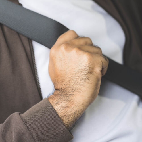 Young asian men getting new car and putting on his seat belt before driving car. Safety drive concept.